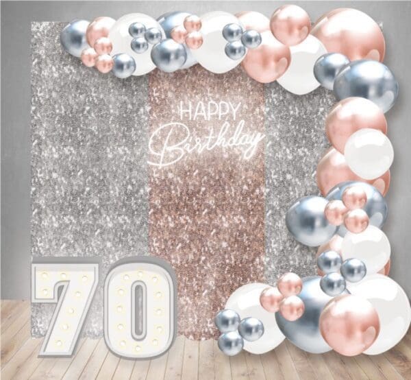Our Birthday Decor Package 23 has a curtain backdrop, NEON sign, large organic balloon arch, and two marquee light-up numbers.