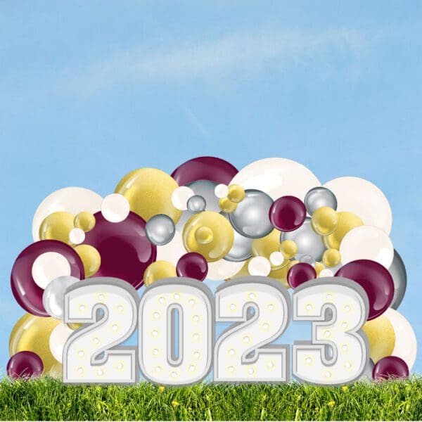 Order Graduation Decor with an organic balloon arch and light-up marquee letters or numbers to represent the occasion.
