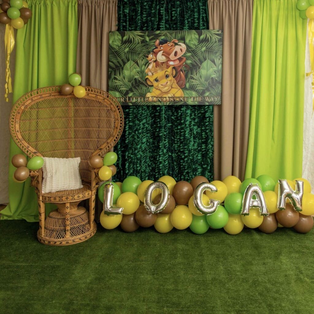 A kids party custom designed for the Lion King. Features green tapestries and multi-colored balloons to match the colors of the film.